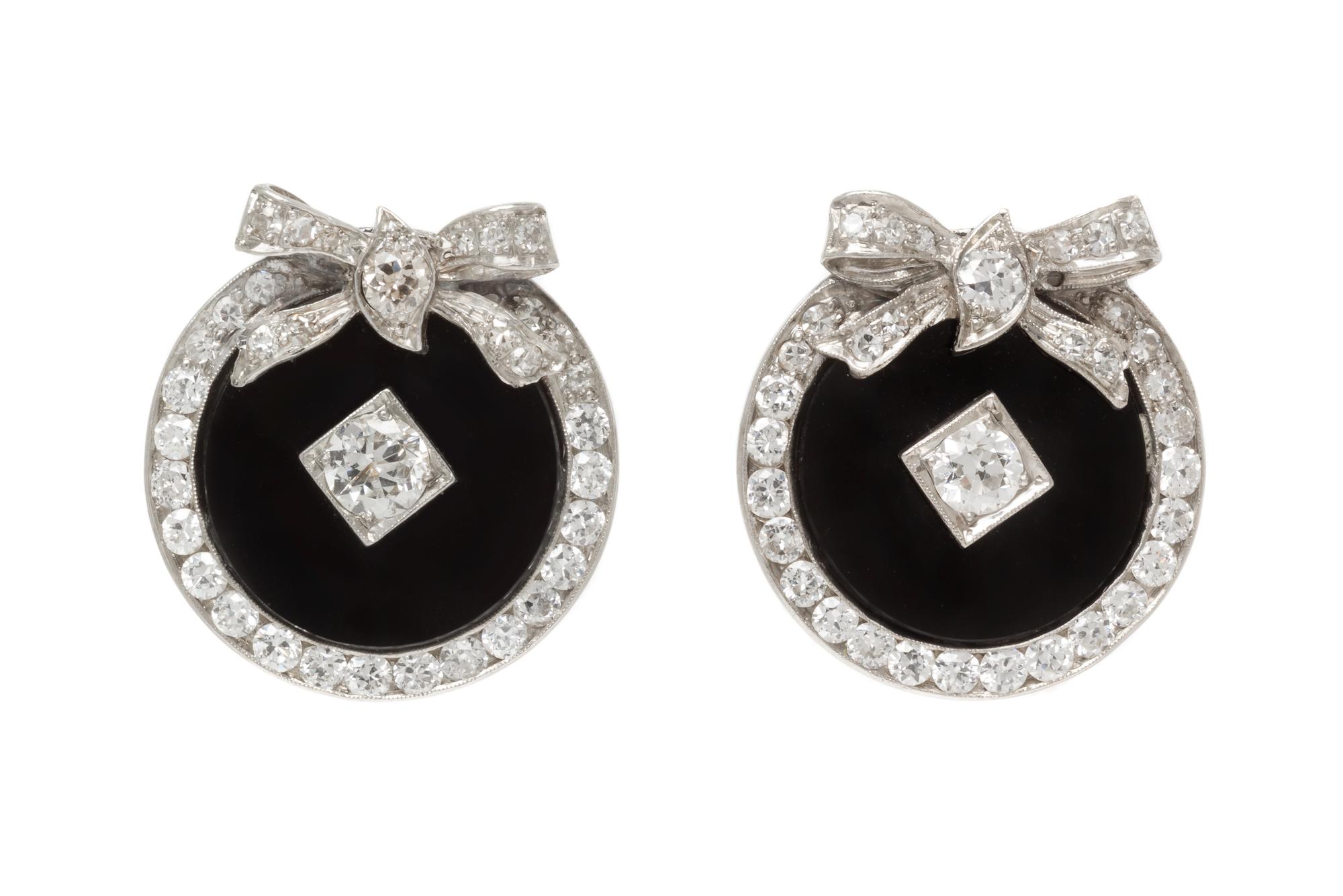 A Pair of Platinum, Diamond and Onyx Earclips, 8.70 dwts.