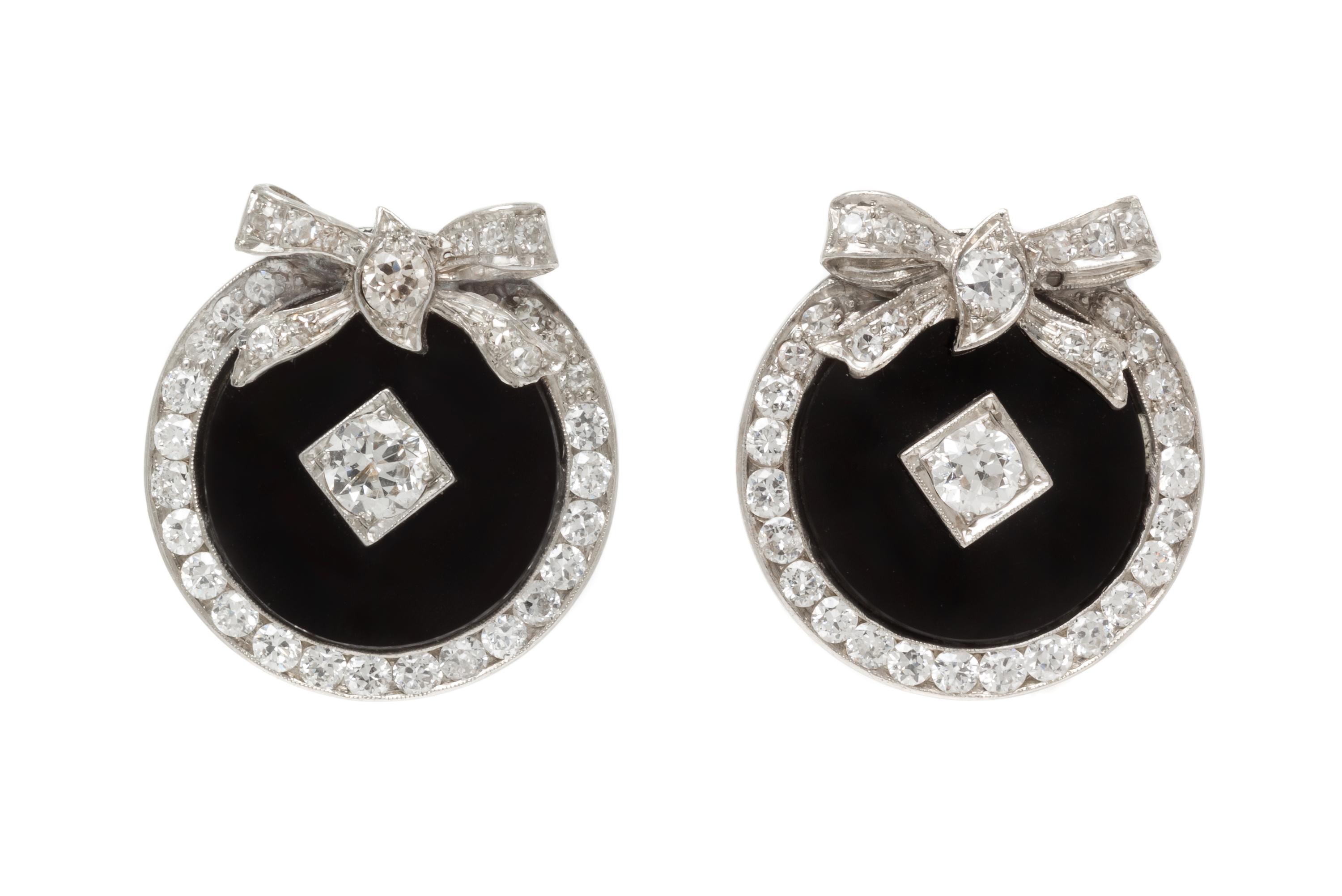 A Pair of Platinum, Diamond and Onyx Earclips, 8.70 dwts.