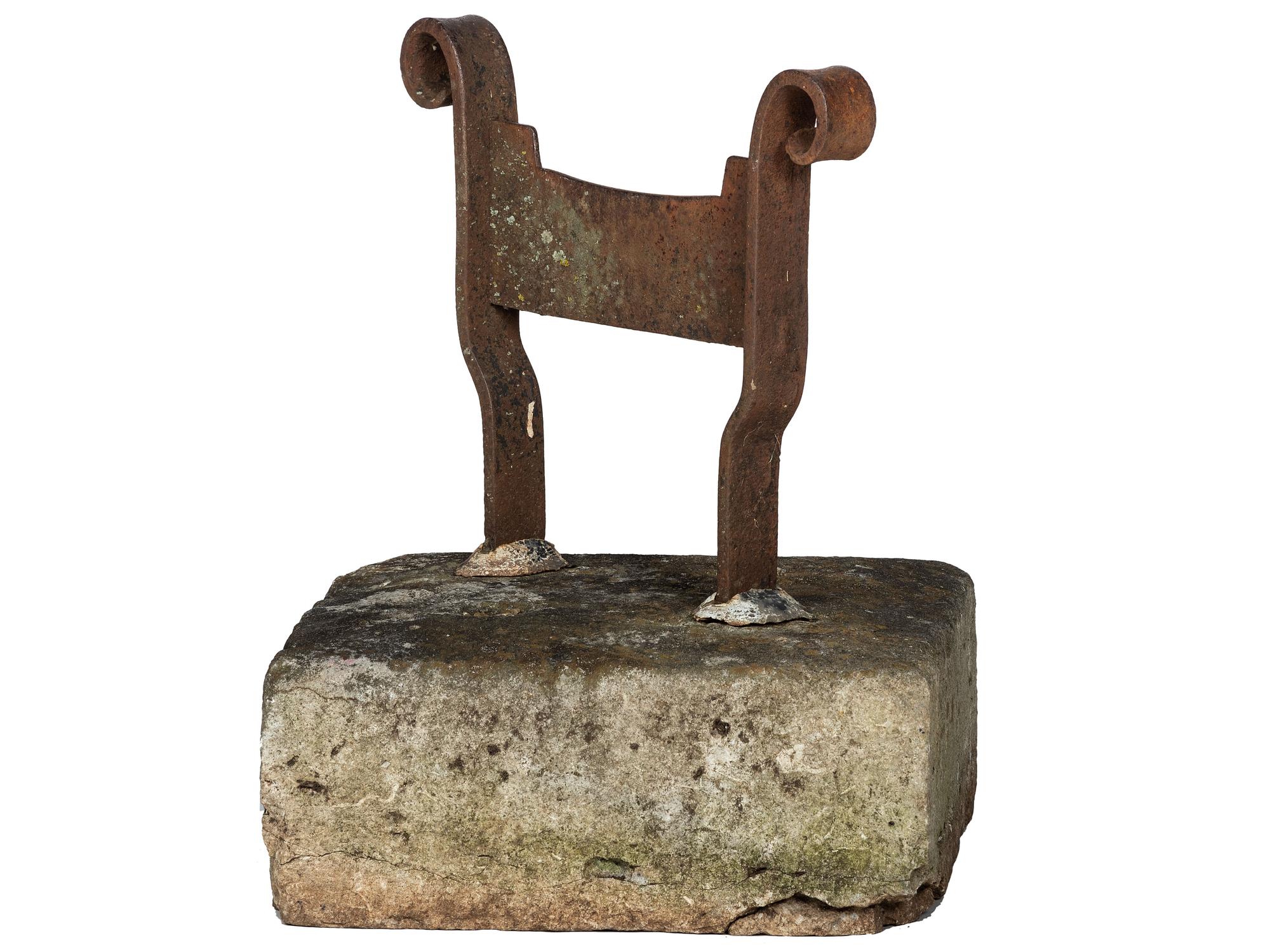 A Wrought Iron Boot Scrape with Stone Base