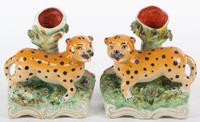 A Pair of Ceramic Bud Vases with Leopard Mounted Base Height 7 inches.