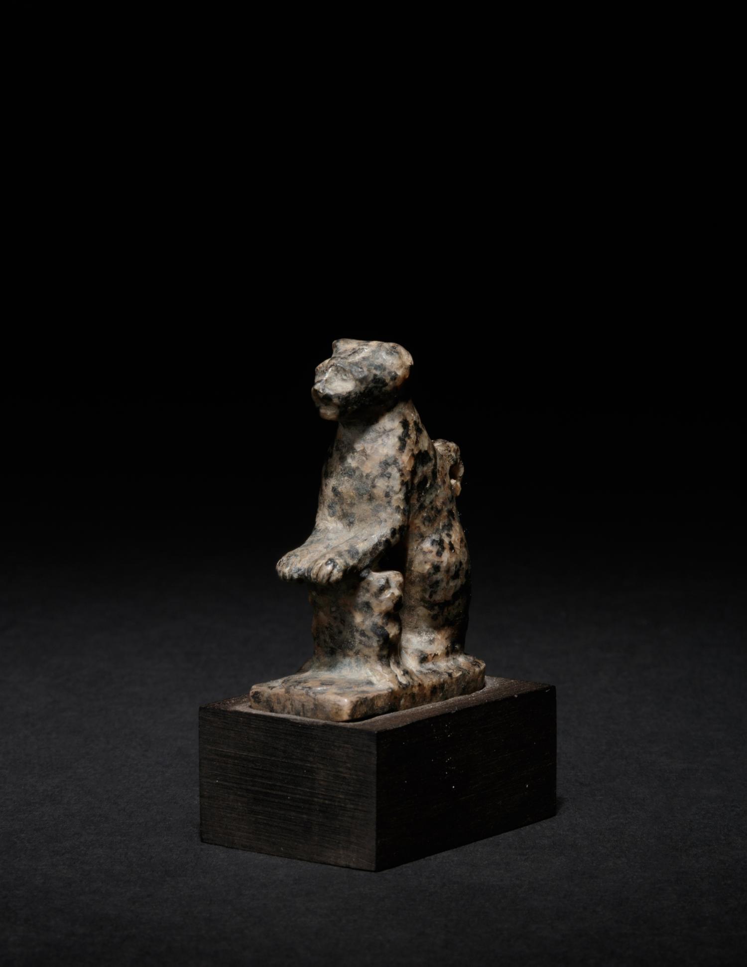 An Egyptian Granite Amulet of a Cat with Kittens