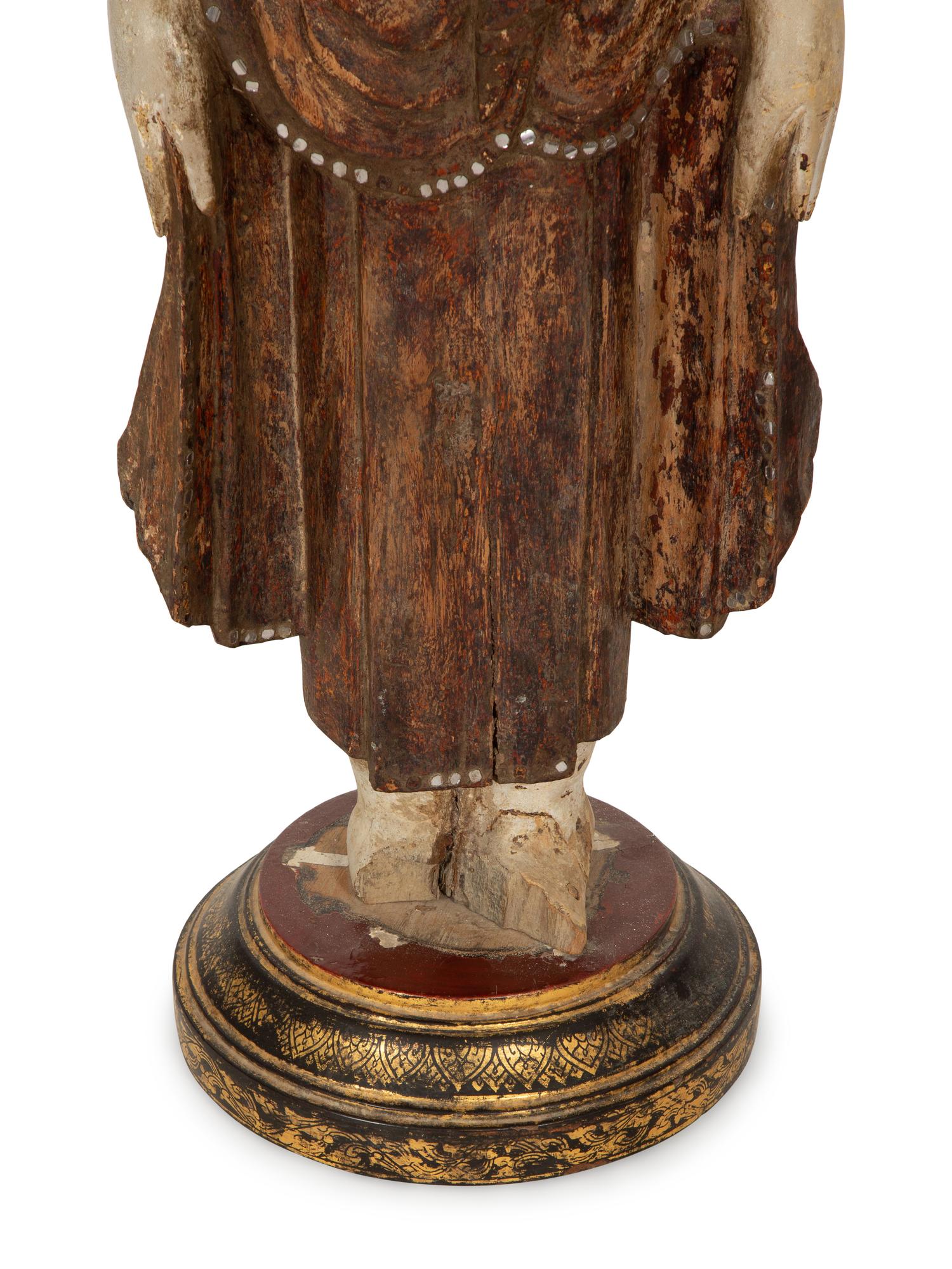 An Indonesian Carved and Painted Figure of a Buddhist Monk