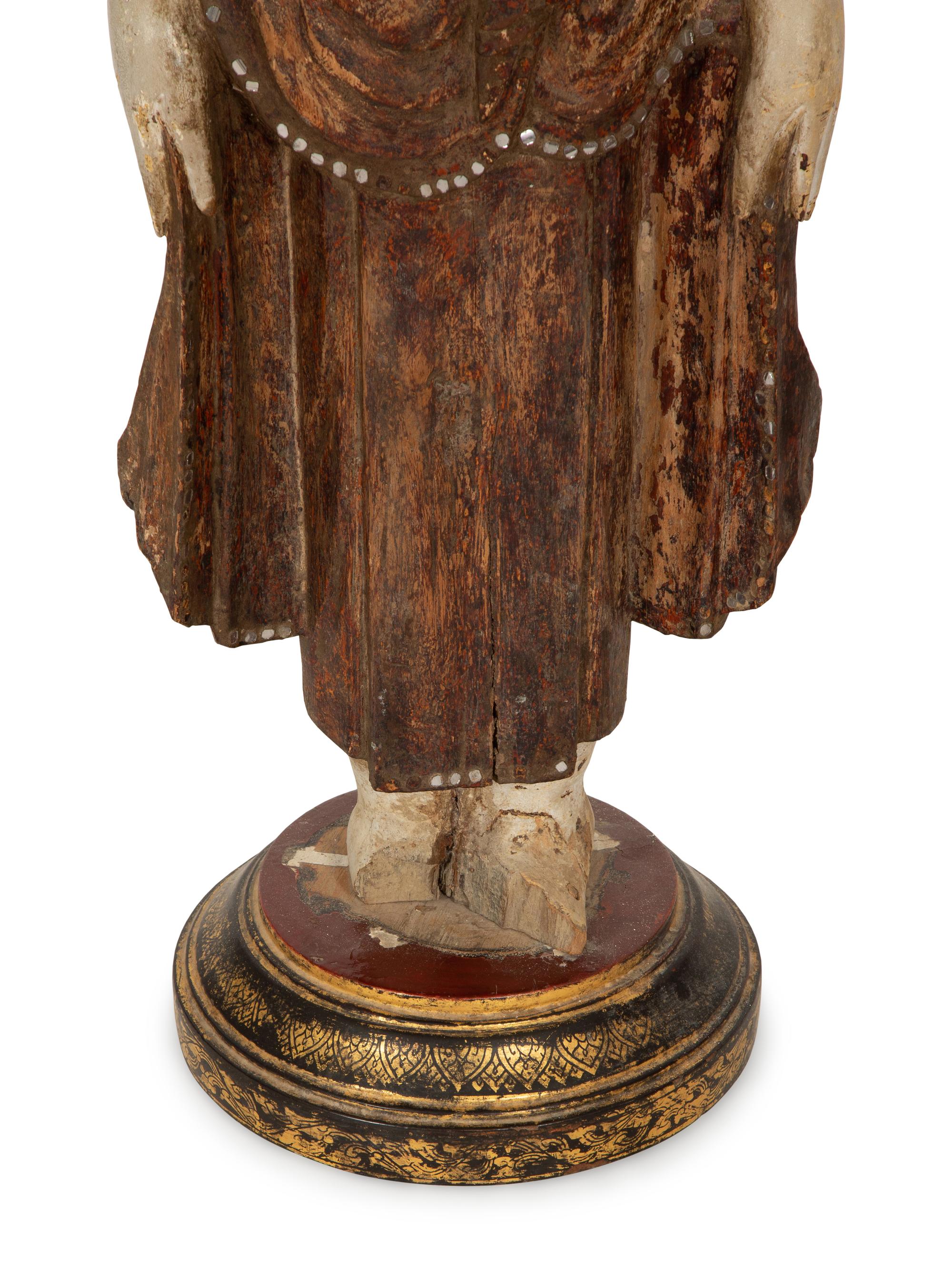An Indonesian Carved and Painted Figure of a Buddhist Monk