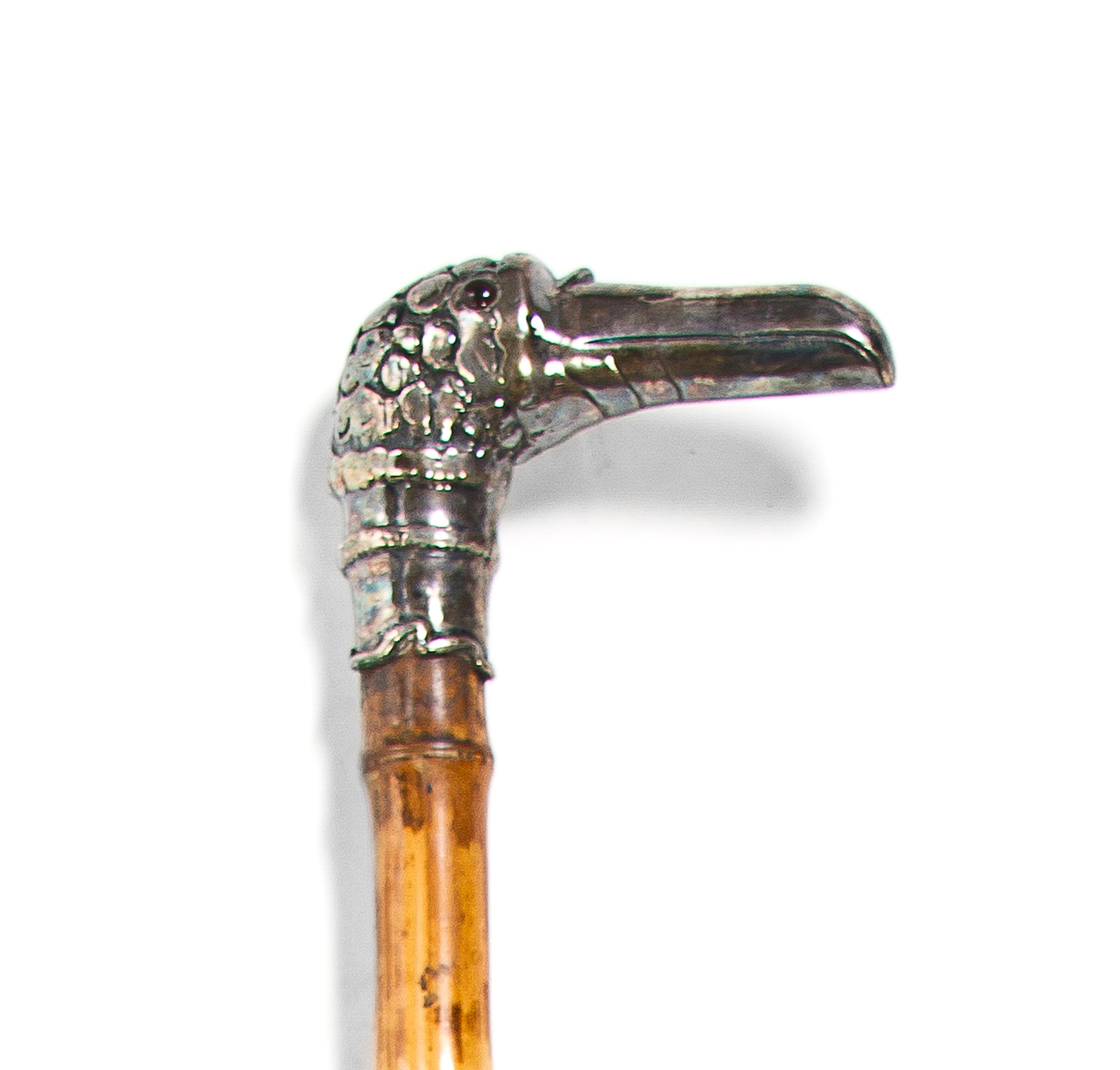 A Silvered Metal Mounted Cane, Height overall 34 1/2 x width of handle 4 3/4 inches.