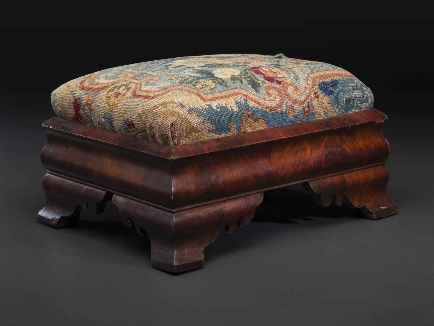 An American Empire Mahogany Veneered and Needlepoint Upholstered Footstool