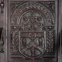 An English Carved Oak and Elm Panel-Back Armchair