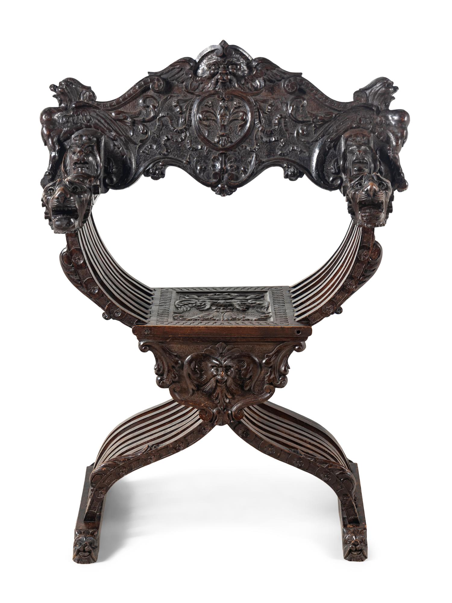 An Italian Renaissance Revival Carved Walnut Savonarola Armchair