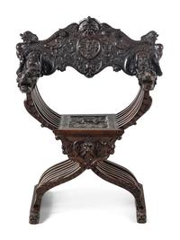 An Italian Renaissance Revival Carved Walnut Savonarola Armchair