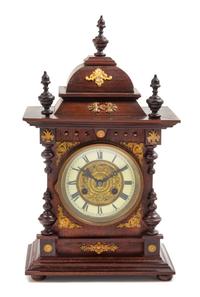 A Continental Gilt Metal Mounted Mahogany Mantel Clock