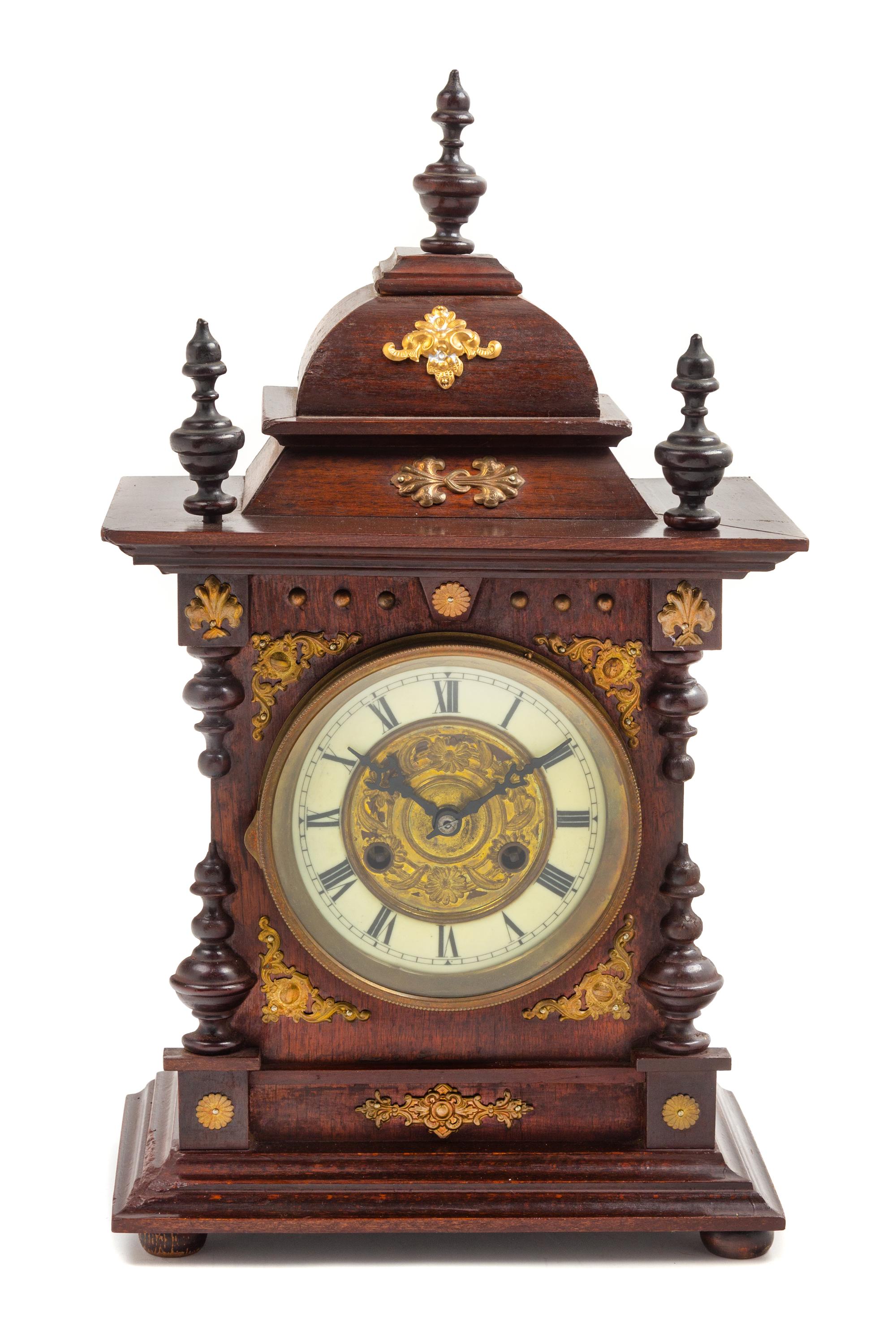 A Continental Gilt Metal Mounted Mahogany Mantel Clock