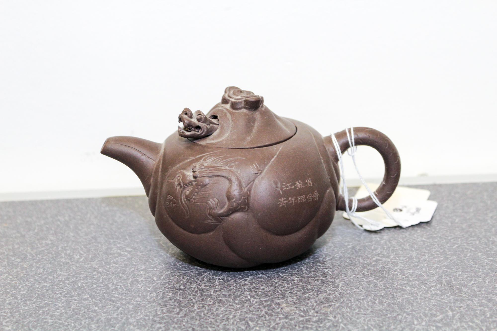 A Yixing Purple Stoneware Teapot and Cover Width 6 1/2 inches.