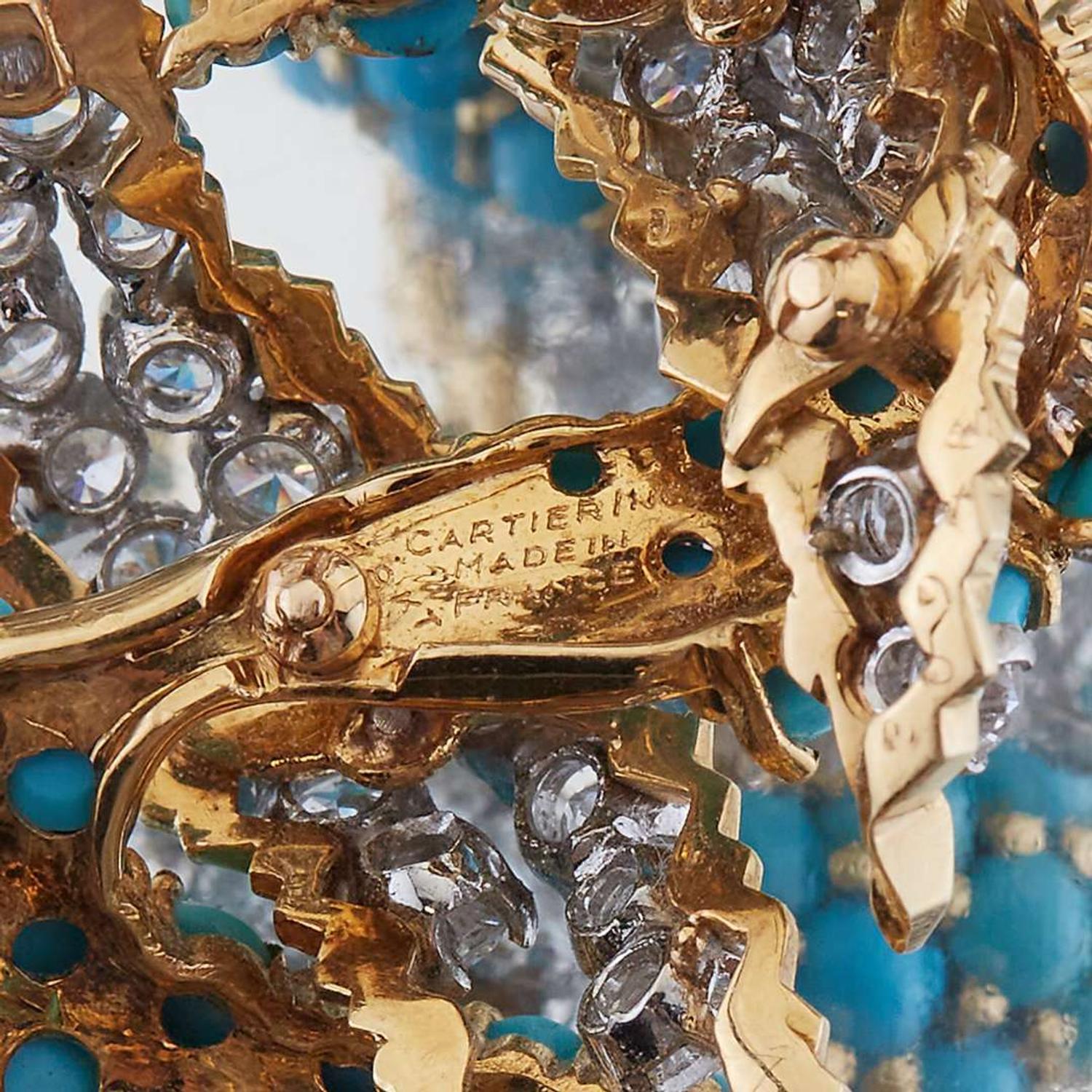 A diamond, turquoise, and eighteen karat gold brooch with matching ear clips, Cartier France