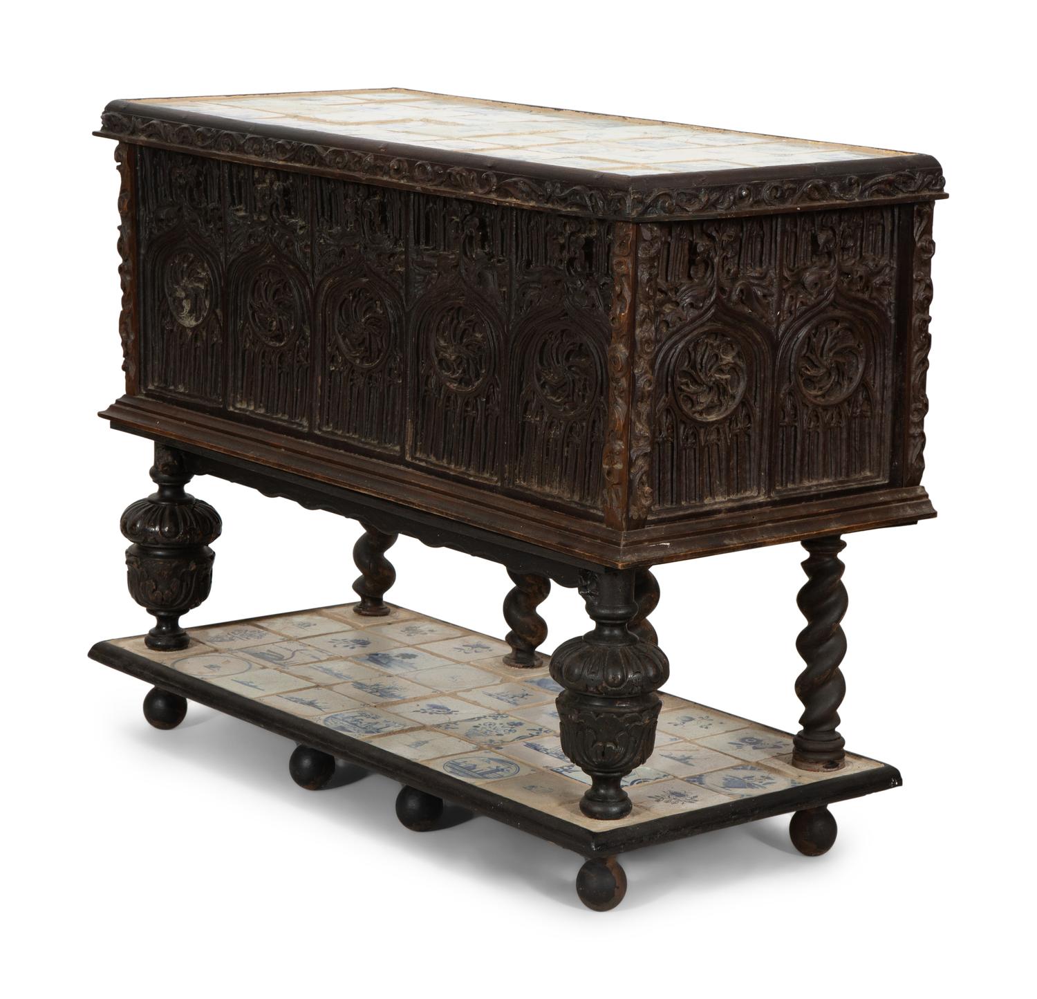 A Gothic Revival Carved Oak Tile-Mounted Chest on Stand