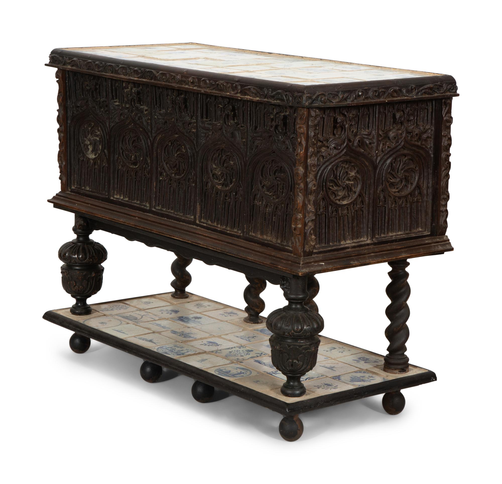 A Gothic Revival Carved Oak Tile-Mounted Chest on Stand