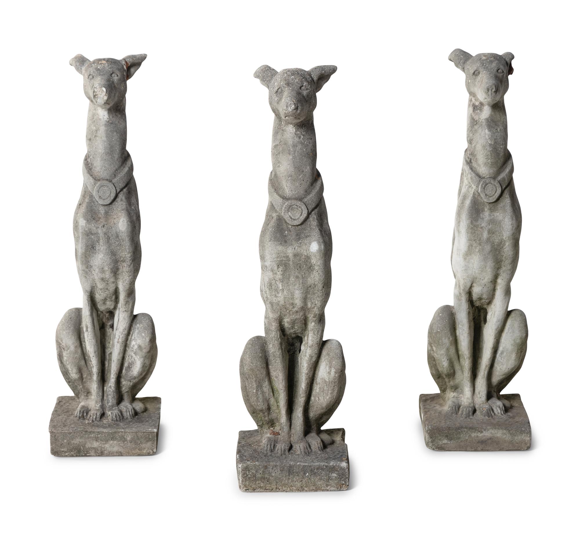 A Group of Cast Stone Hound Form Garden Statues