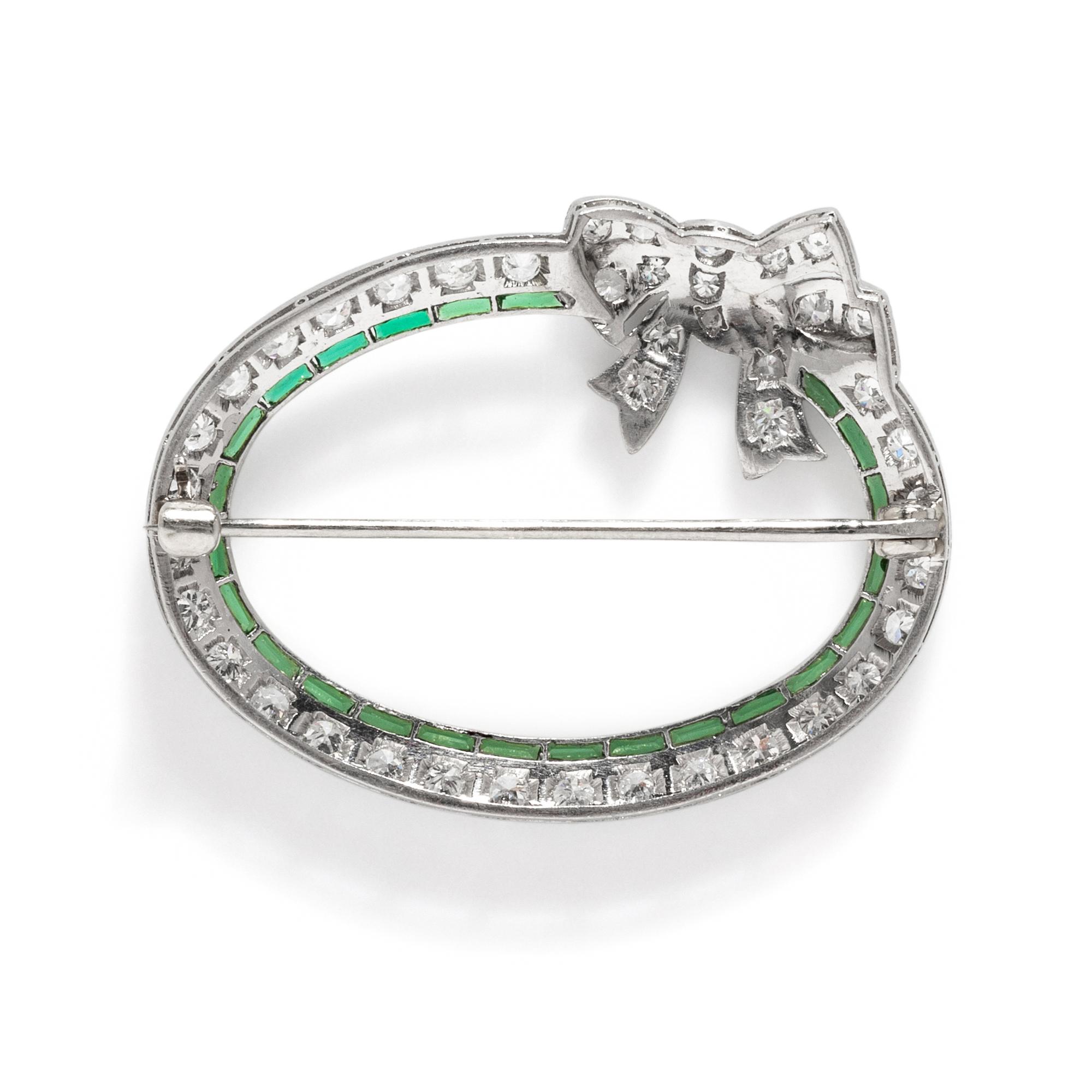 ART DECO, PLATINUM, DIAMOND, AND SYNTHETIC EMERALD BOW BROOCH