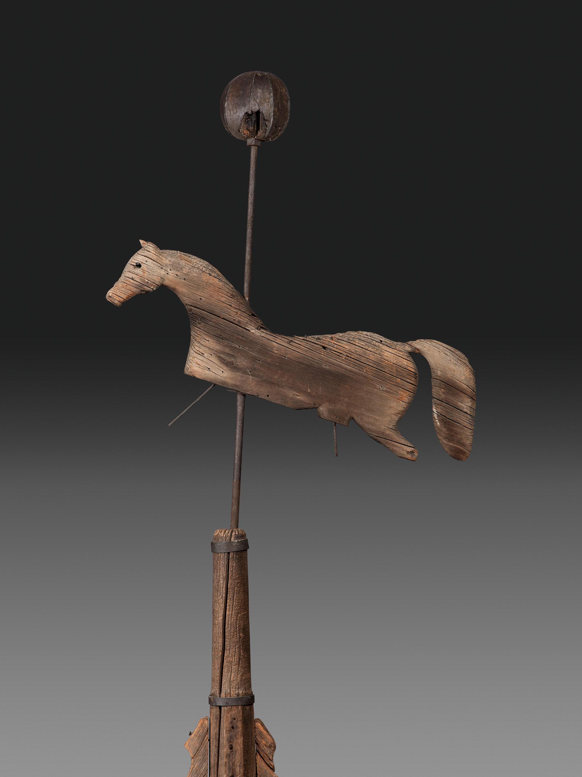 A Primitive Carved Pine and Cast Iron Horse Weathervane on Stand