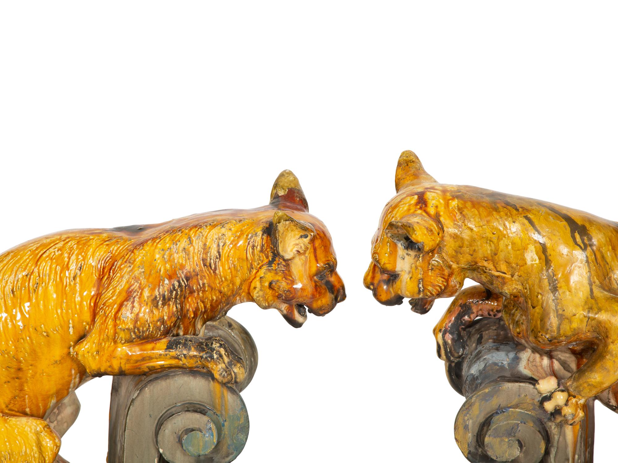 A Pair of Continental Glazed Terra Cotta Fox Roof Ornaments