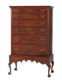 A Chippendale Carved and Figured Walnut Chest on Claw-and-Ball Foot Stand