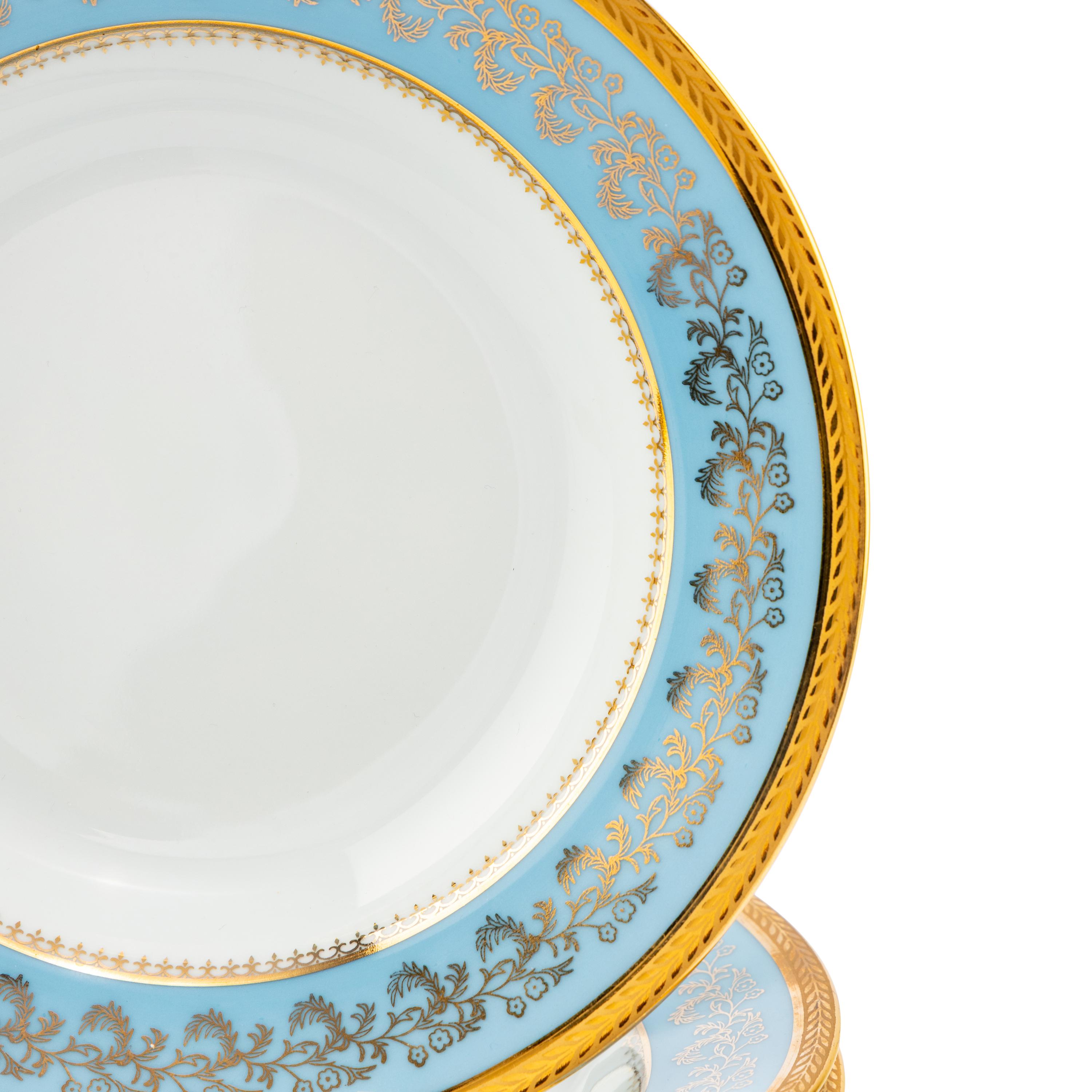 A Set of Eight Limoges Porcelain Soup Plates