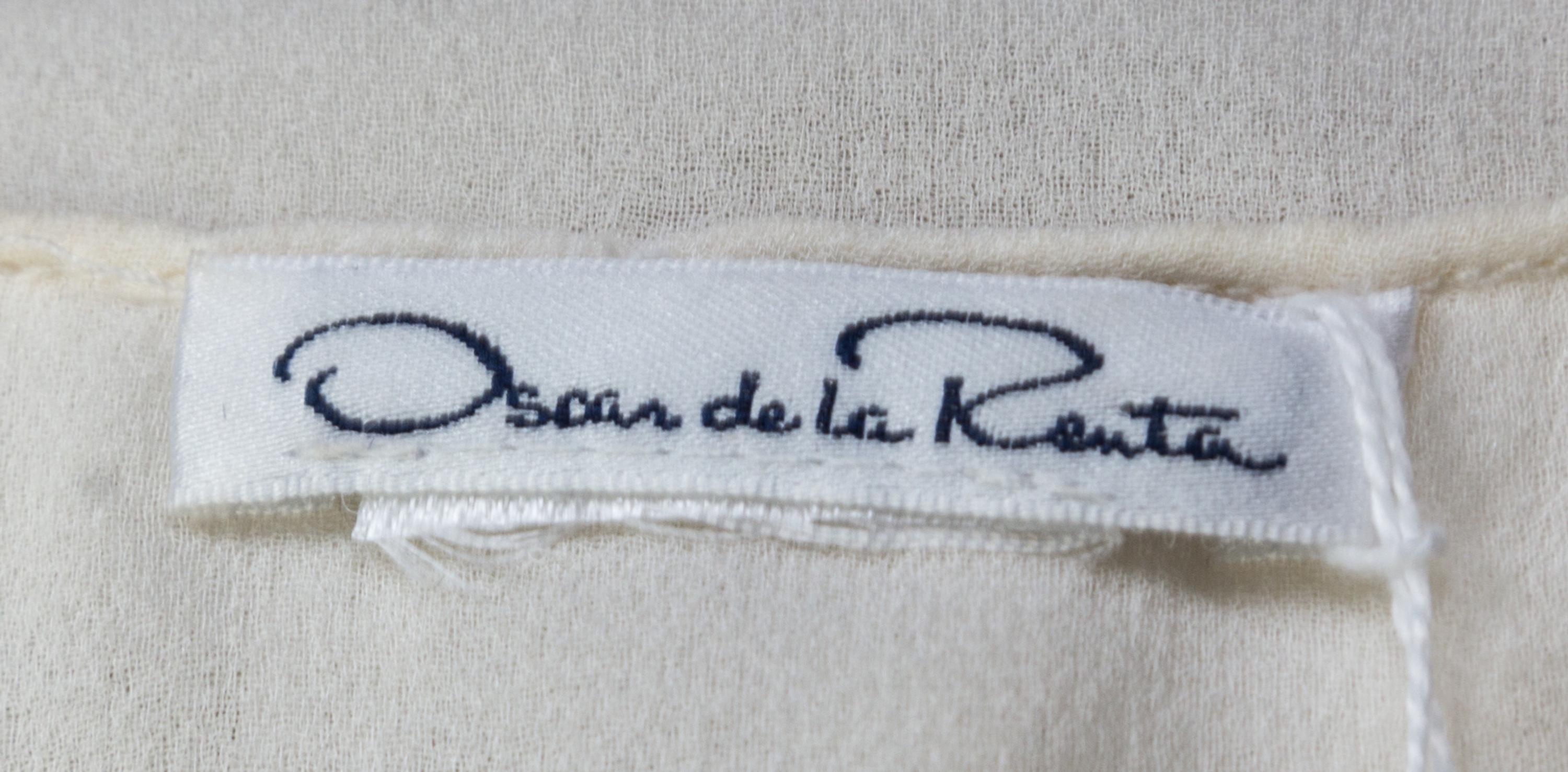 An Oscar de la Renta Cream Silk Blouse,