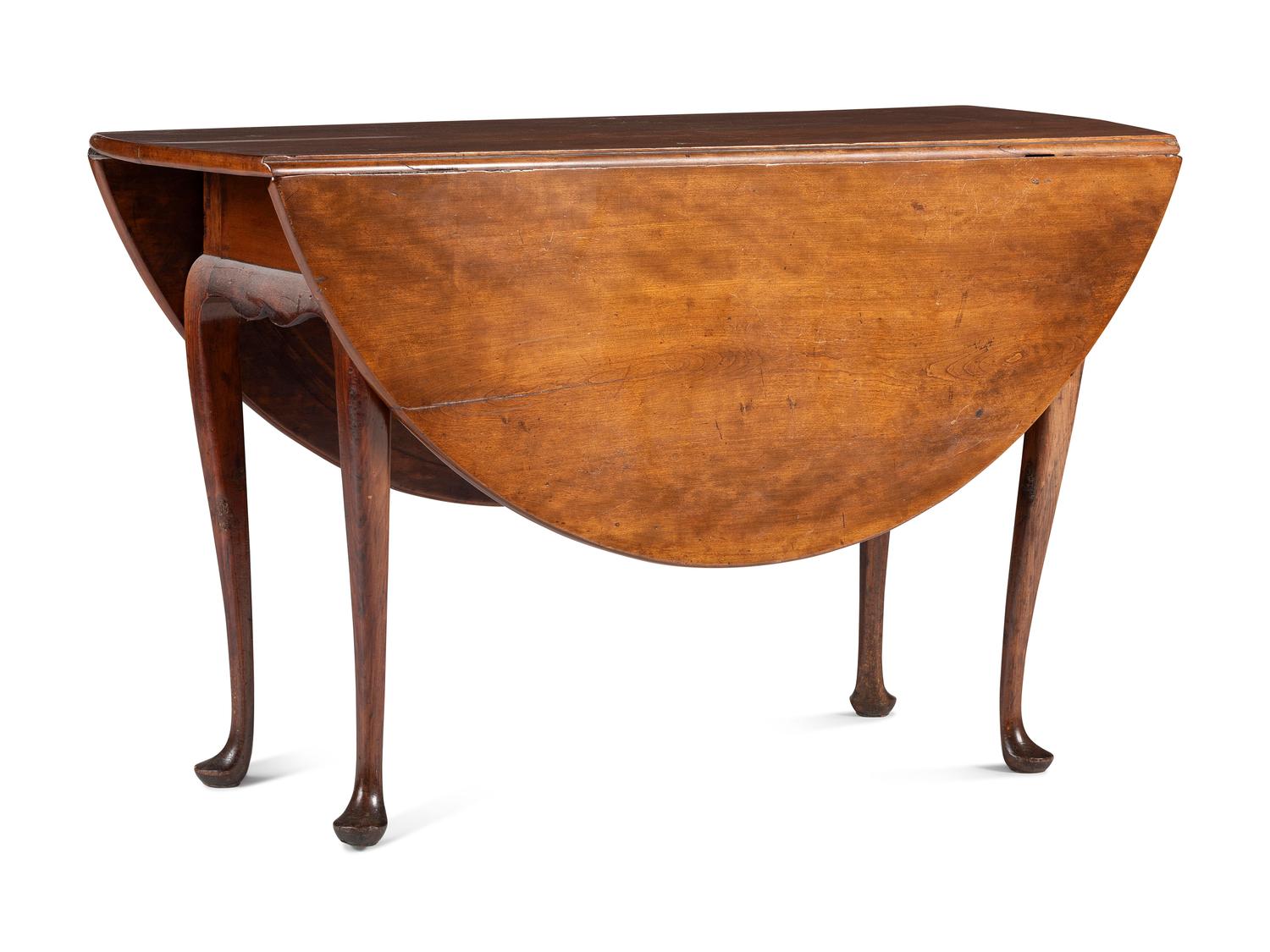 A Queen Anne Carved Cherrywood Drop-Leaf Pad-Foot Dining Table