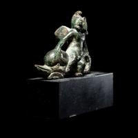 A Roman Bronze Eros Riding a Dolphin