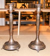A Pair of Mexican Silver Candlesticks, , having a baluster form cup surmounting a tapering stem and stepped base, raised on three pierc