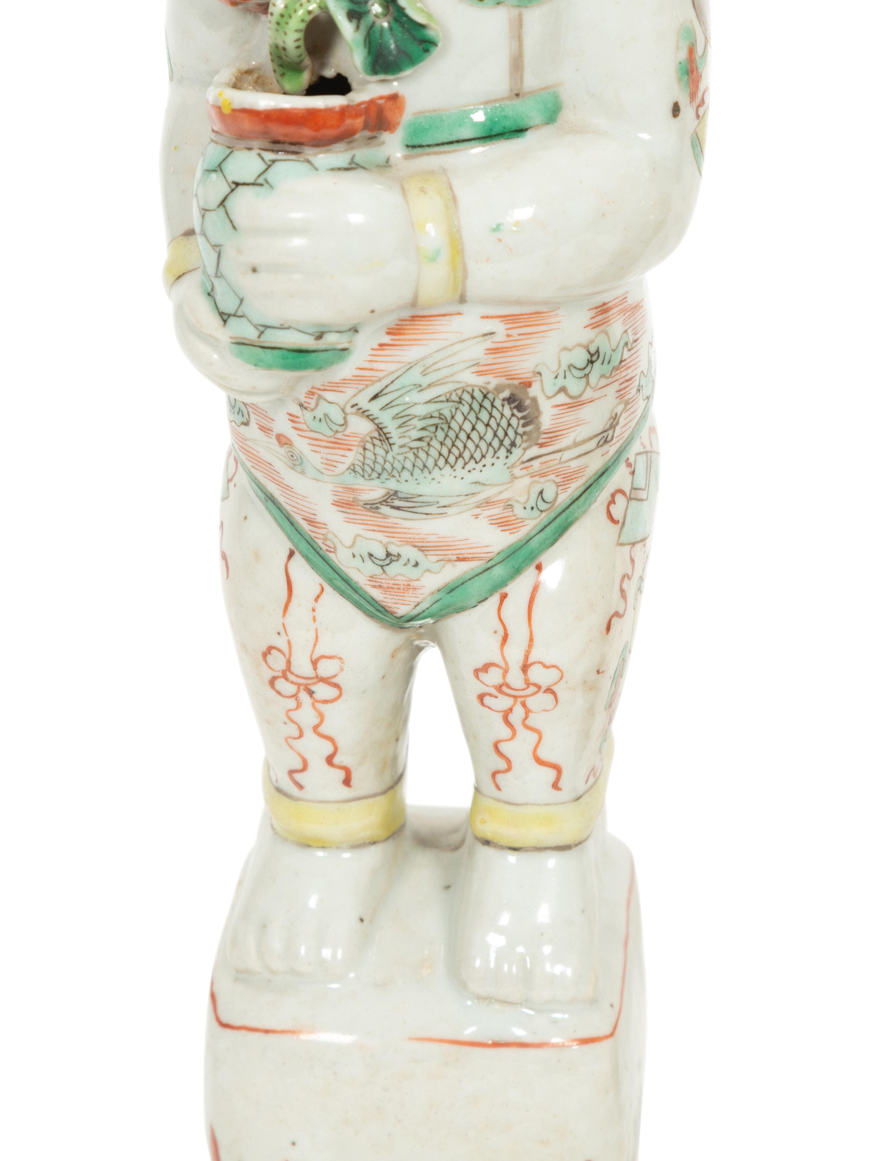 A Pair of Chinese Porcelain Figures of Boys