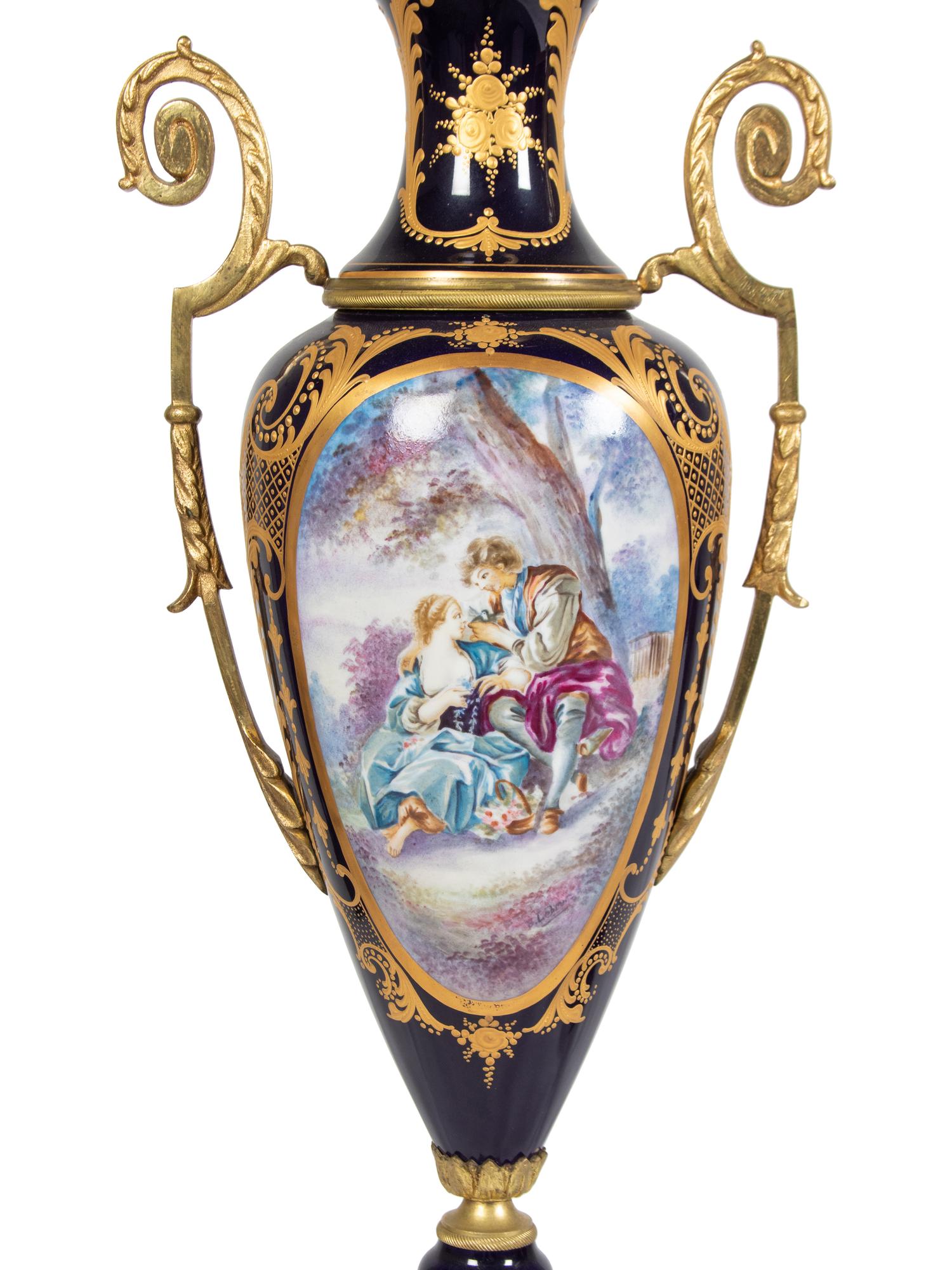 A Pair of Sèvres Style Gilt Metal Mounted Porcelain Covered Urns