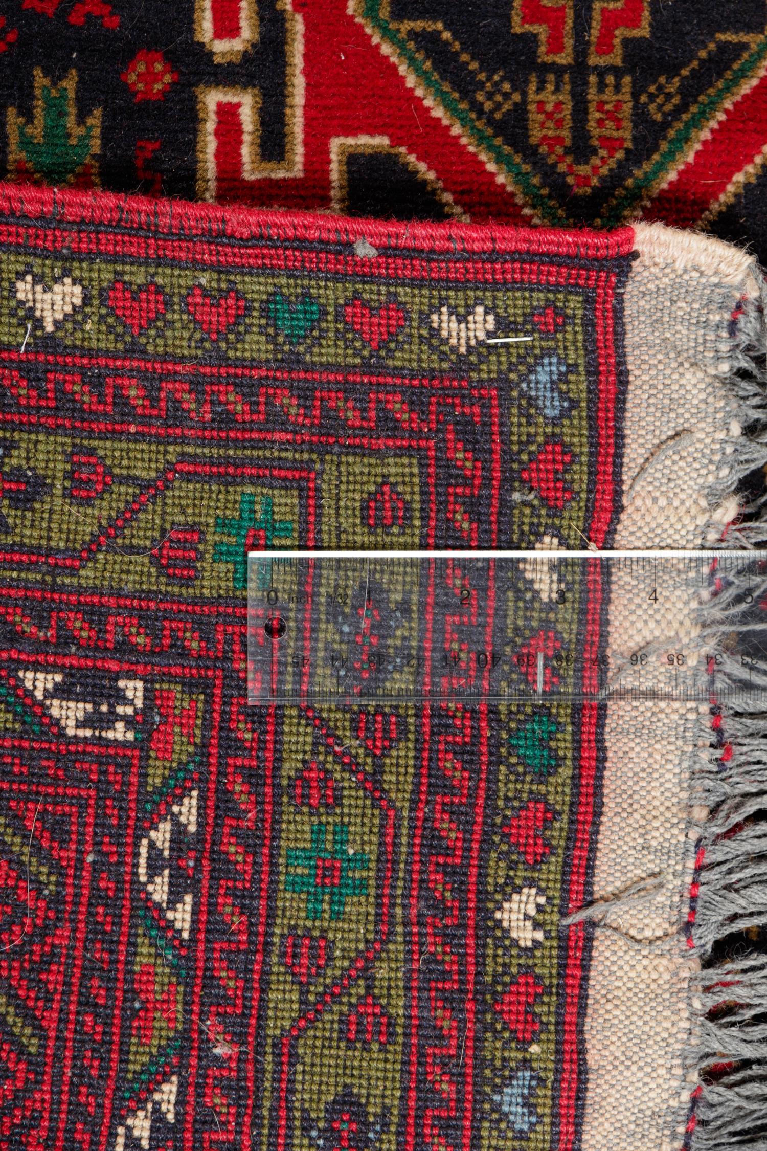 A Persian Bokhara Wool Rug