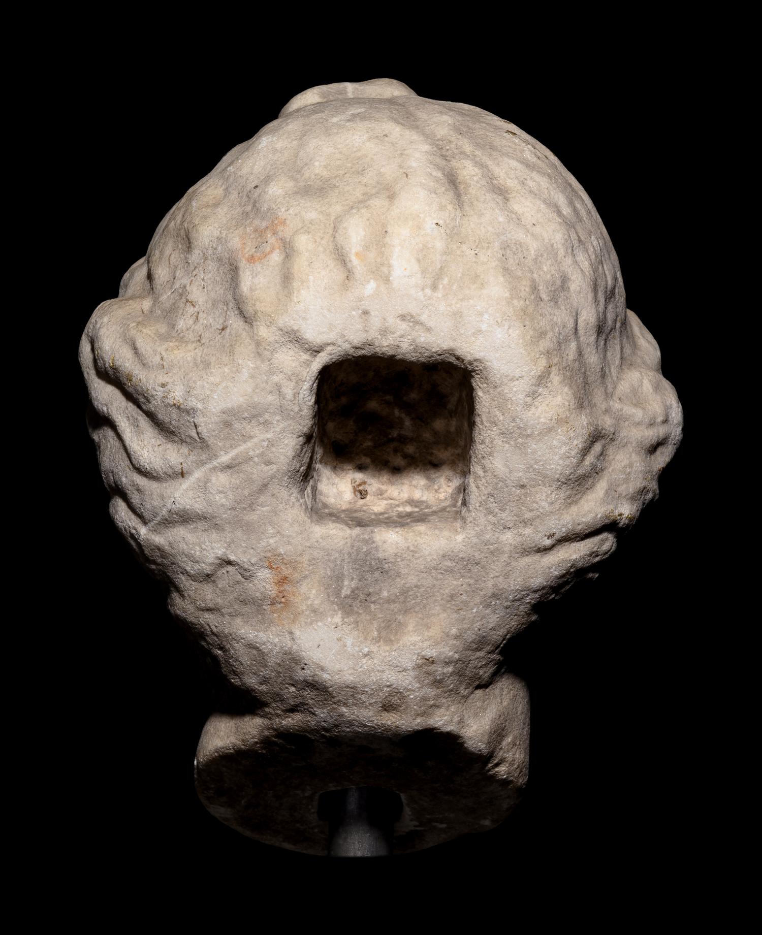 A Roman Marble Head of a Woman with Plaited Hair and Ribbon