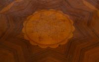 An Empire Style Inlaid Beechwood and Parcel Gilt Center Table by Hurtado