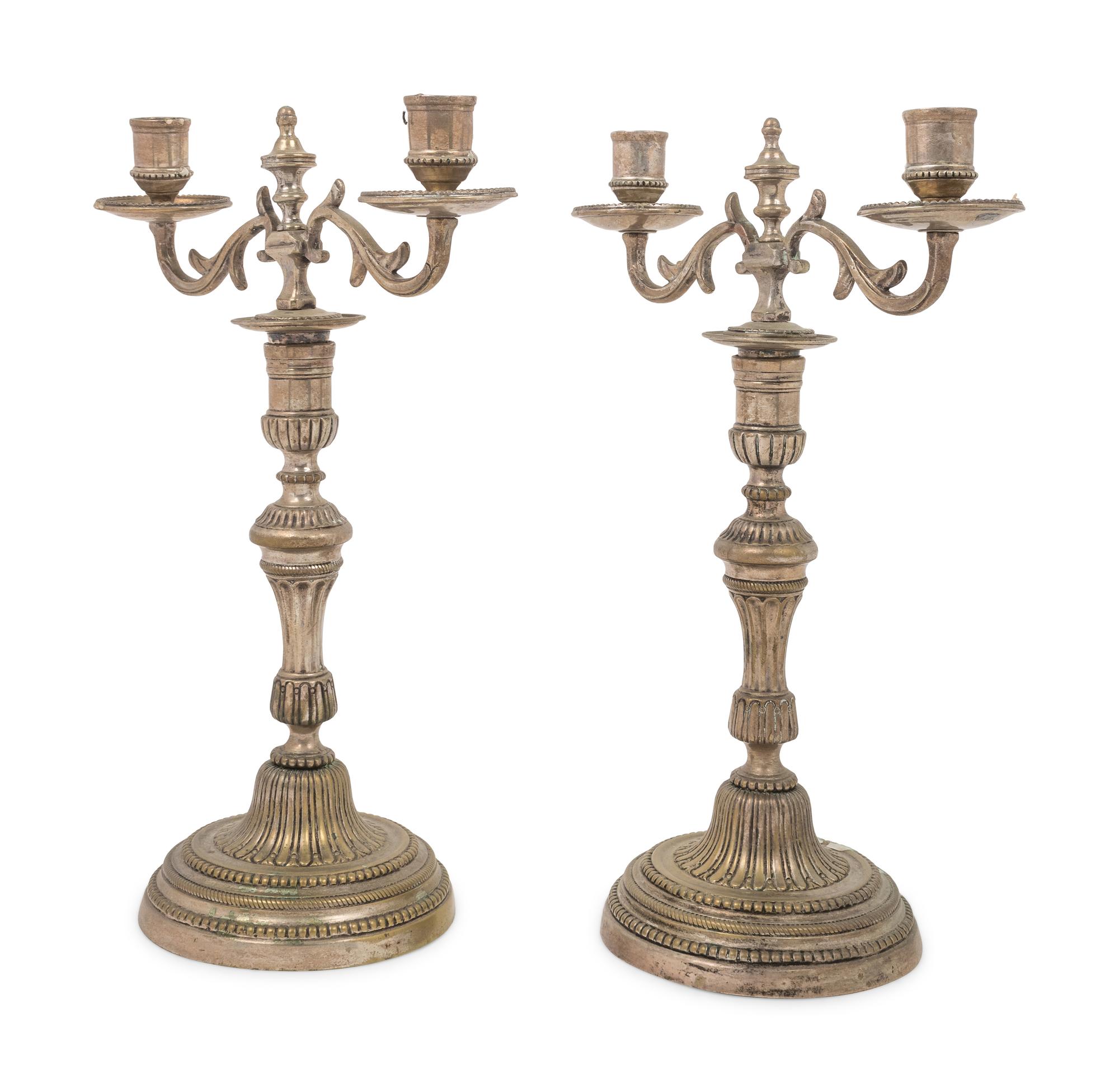 A Pair of Silvered Brass Two-Light Candelabra