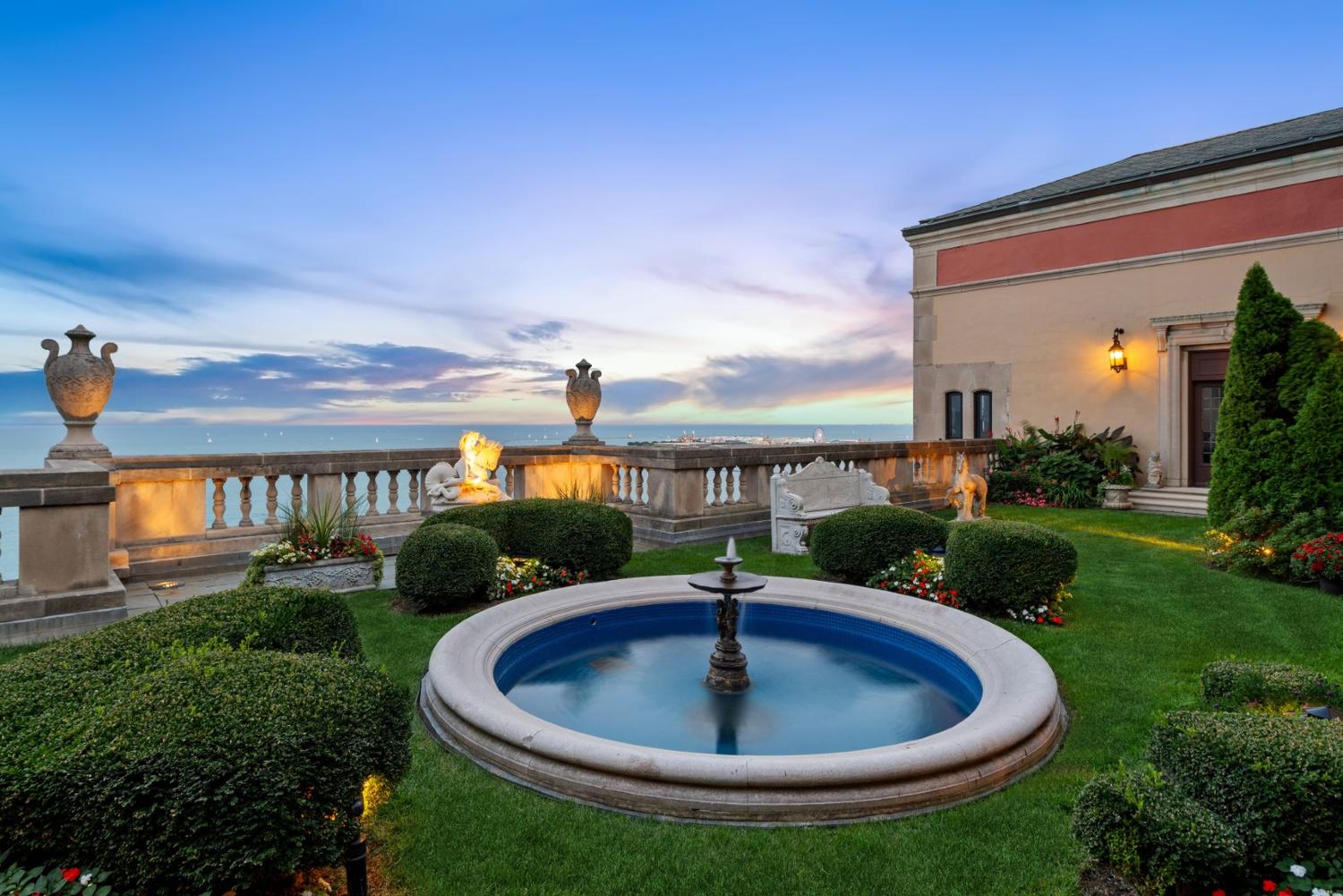A Renaissance Revival Style Carved Walnut Faux Marble-Top Dining Table