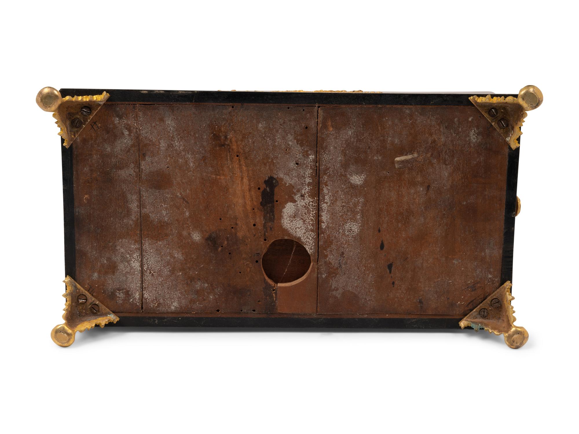 A French Gilt Bronze and Parcel Ebonized Burlwood Encrier