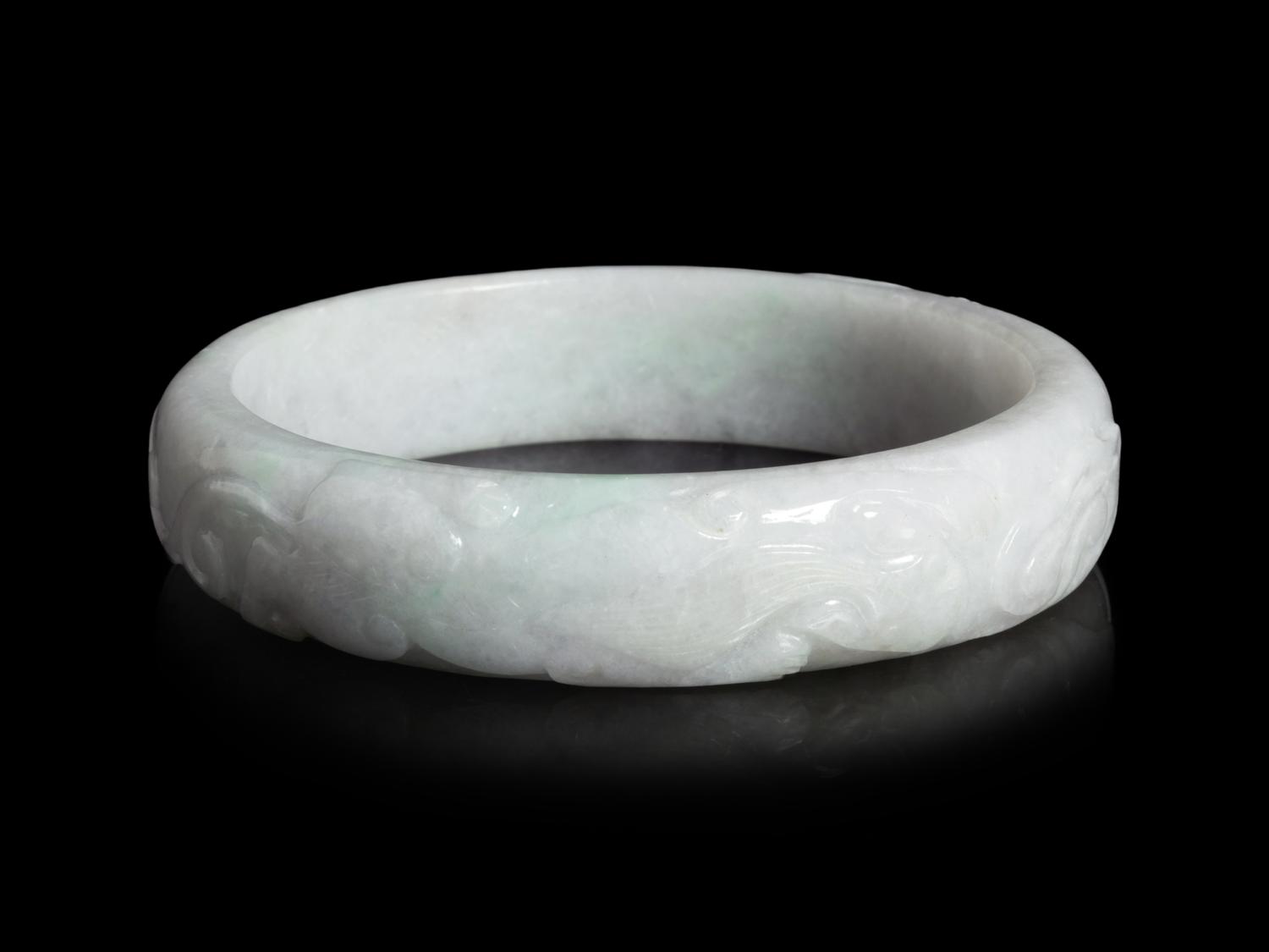 A Large Chinese Carved Jadeite Bangle