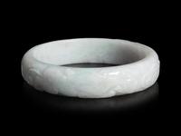 A Large Chinese Carved Jadeite Bangle