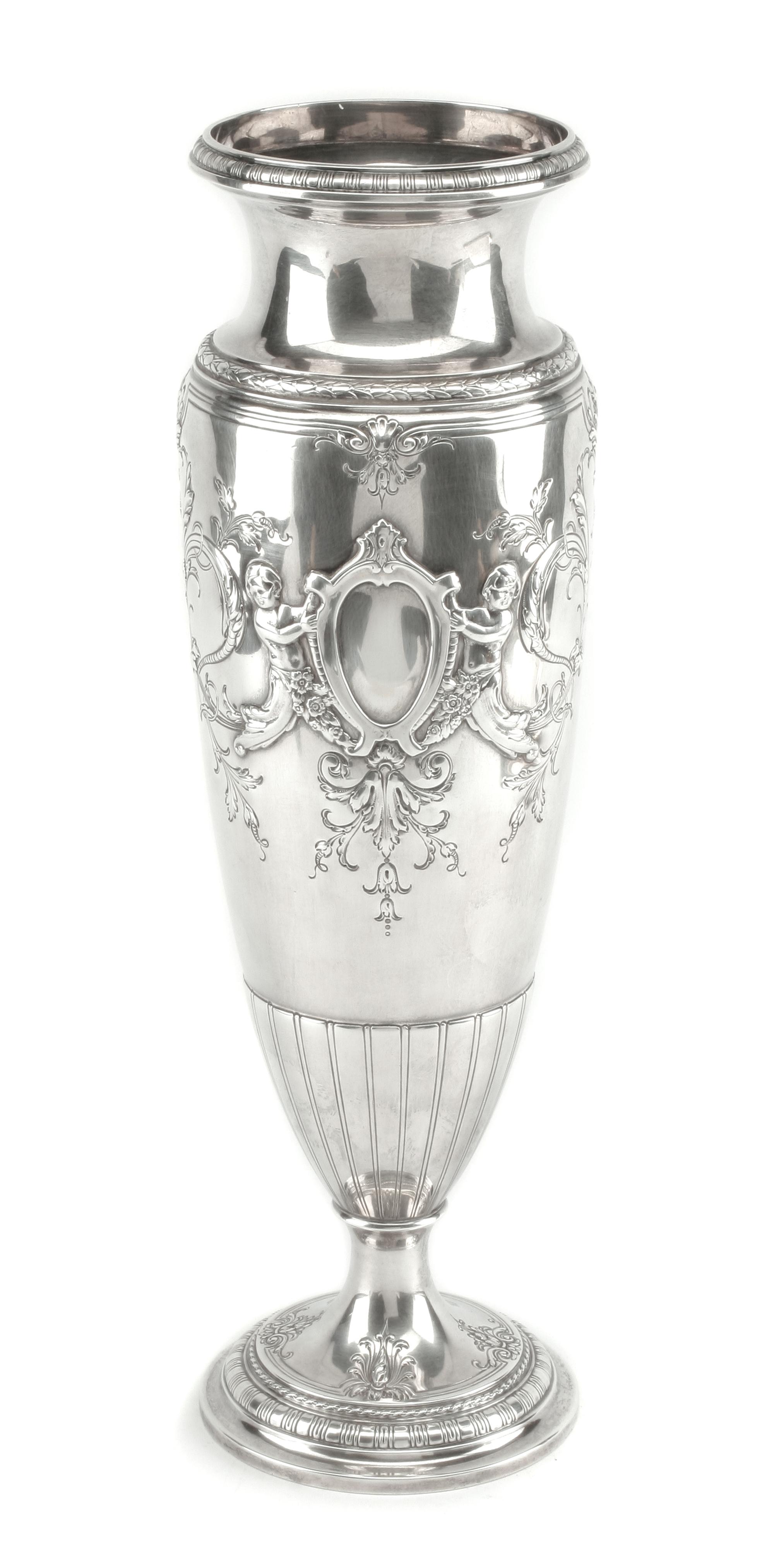 An American Silver Vase, International Silver Co., Meriden, CT, of elongated baluster form, the body worked to show two vacant cartouch
