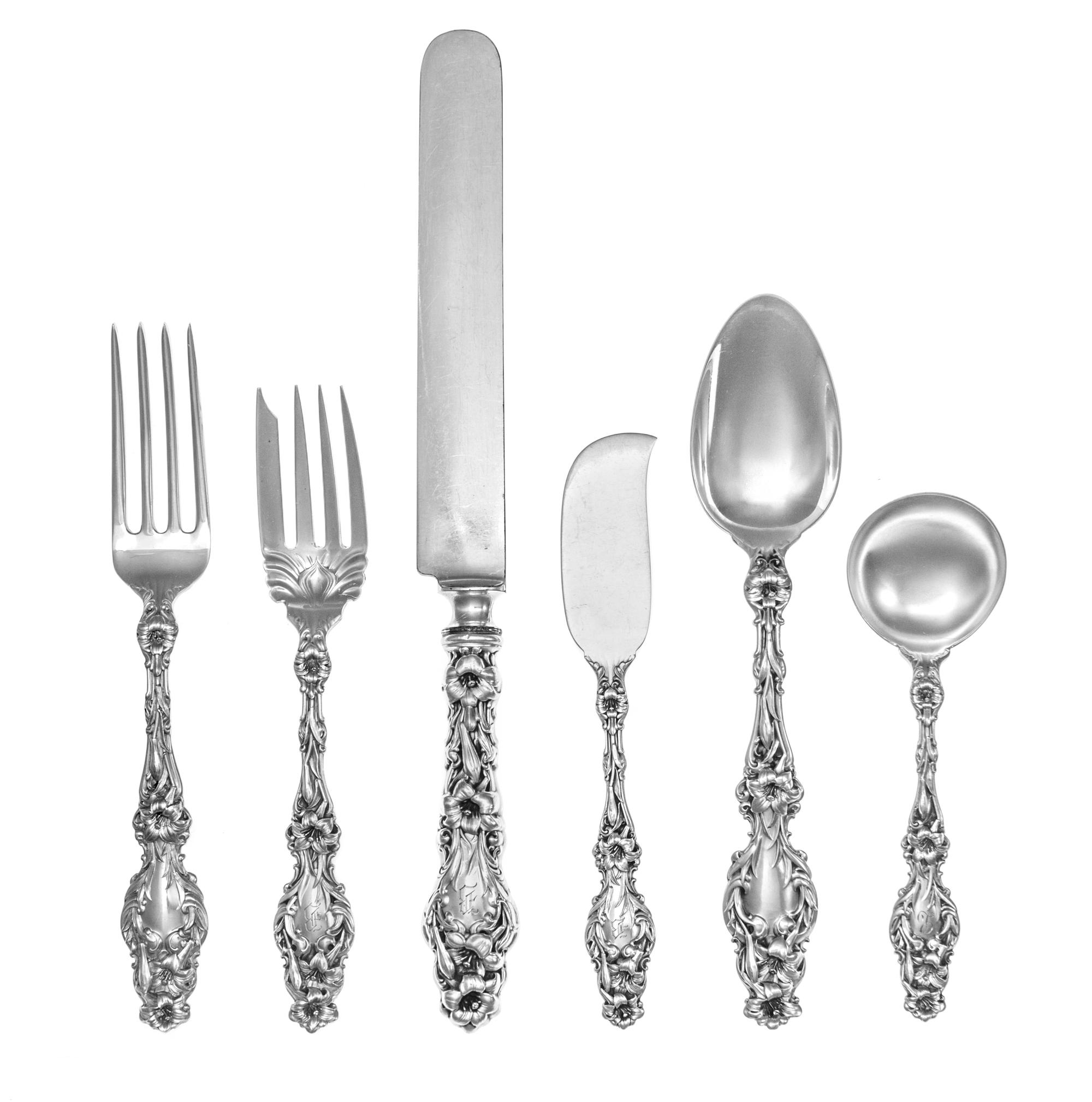 An American Silver Flatware Service, Whiting Mfg. Co., New York, NY, Lily pattern, comprising: 12 dinner knives 12 dinner forks 20 lunc