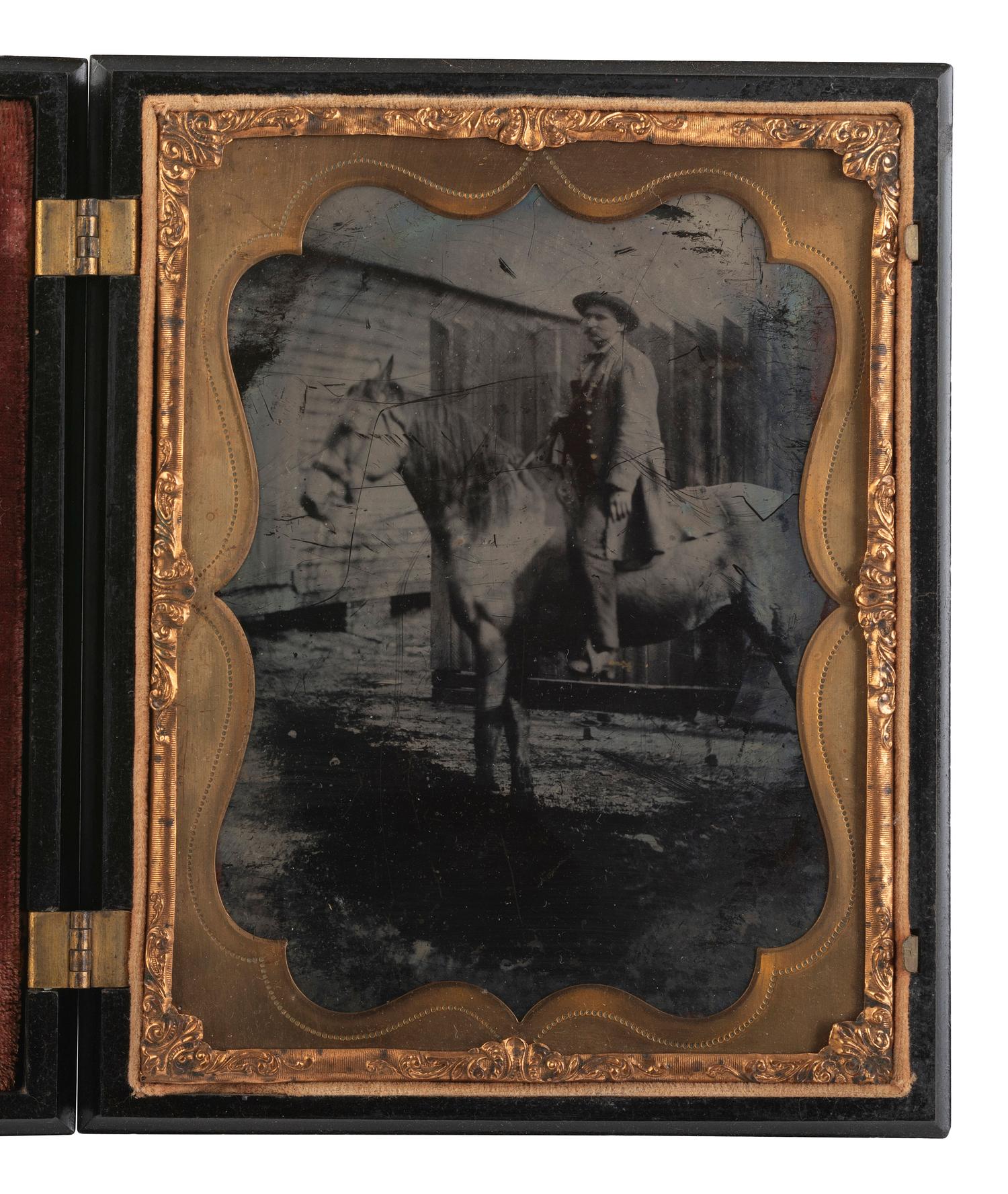 [EARLY PHOTOGRAPHY]. Half plate ambrotype of man on horseback with Washington Monument Union case.
