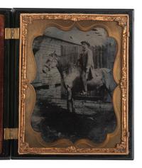 [EARLY PHOTOGRAPHY]. Half plate ambrotype of man on horseback with Washington Monument Union case.