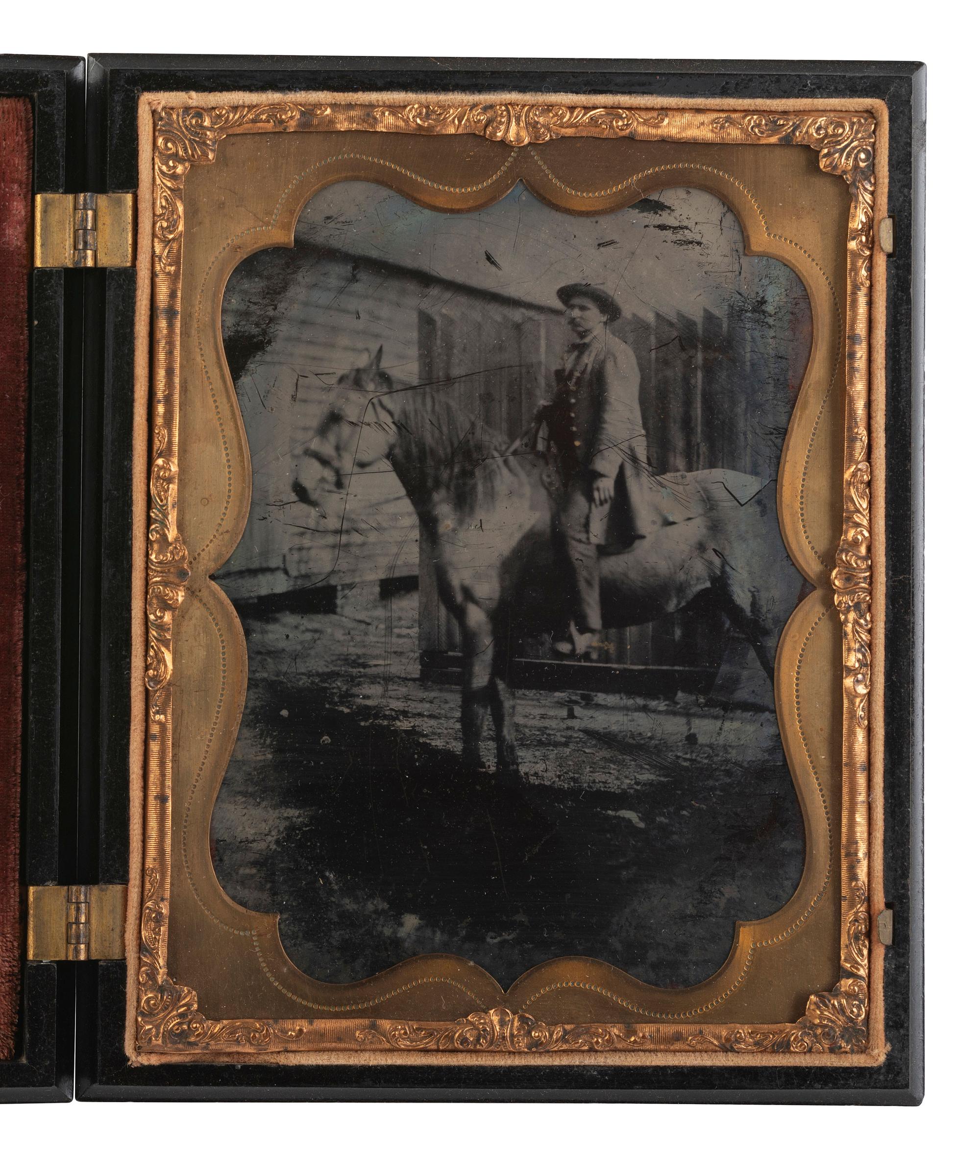 [EARLY PHOTOGRAPHY]. Half plate ambrotype of man on horseback with Washington Monument Union case.