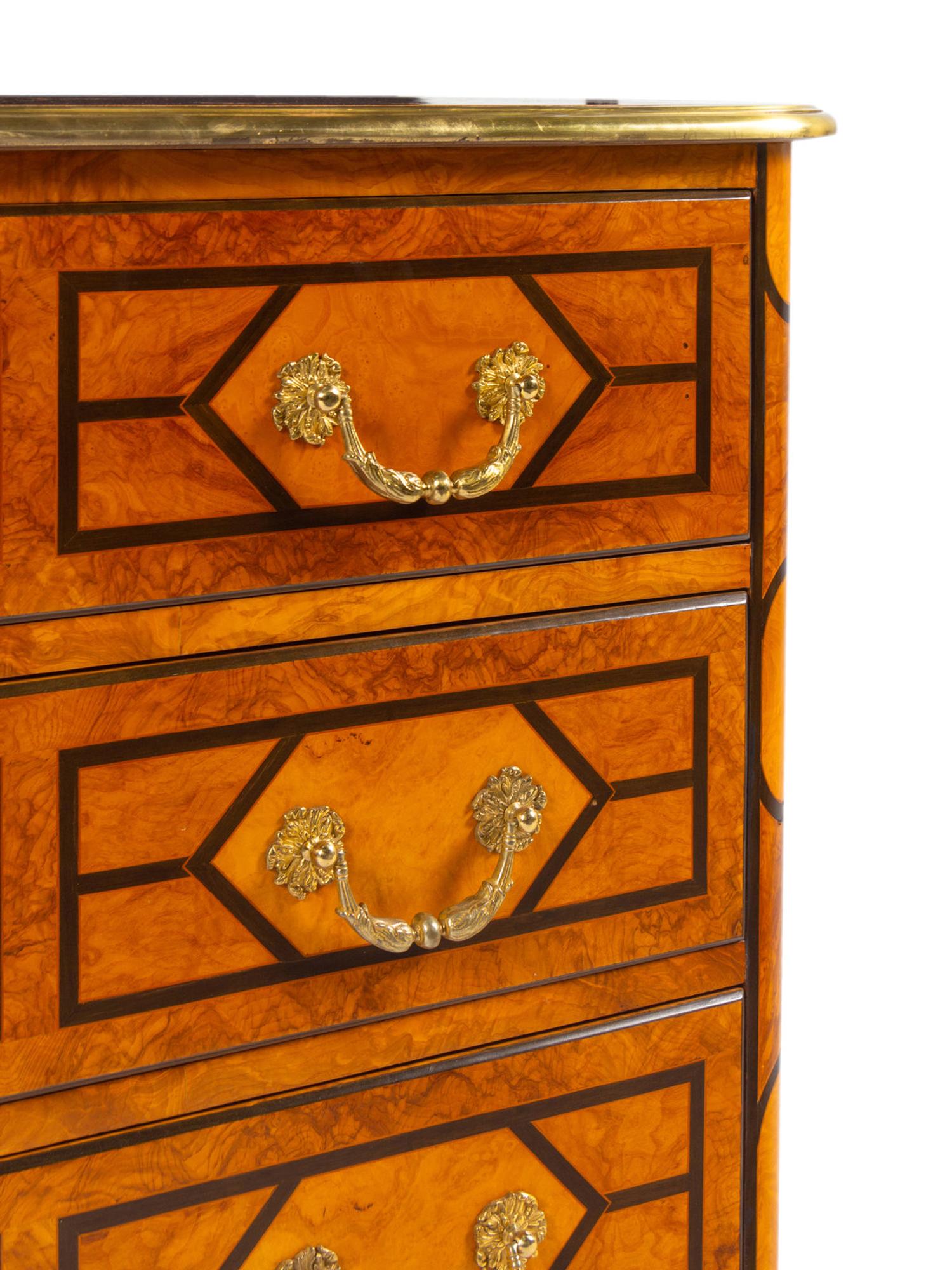 A Régence Style Gilt Metal Mounted Burl Walnut Chest of Drawers