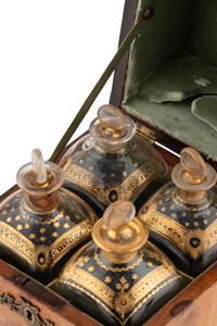 A Walnut and Mahogany Tantalus and Three Silver-Mounted Horn Tumblers