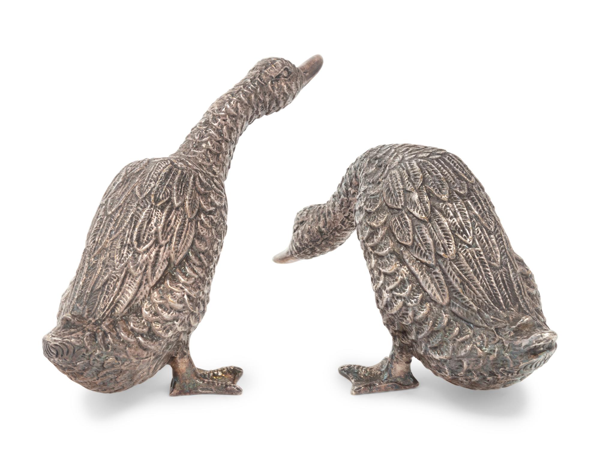 Two Silver Duck Figures