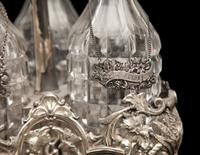 An English Silver-Plate Tantalus with Three Cut Glass Decanters