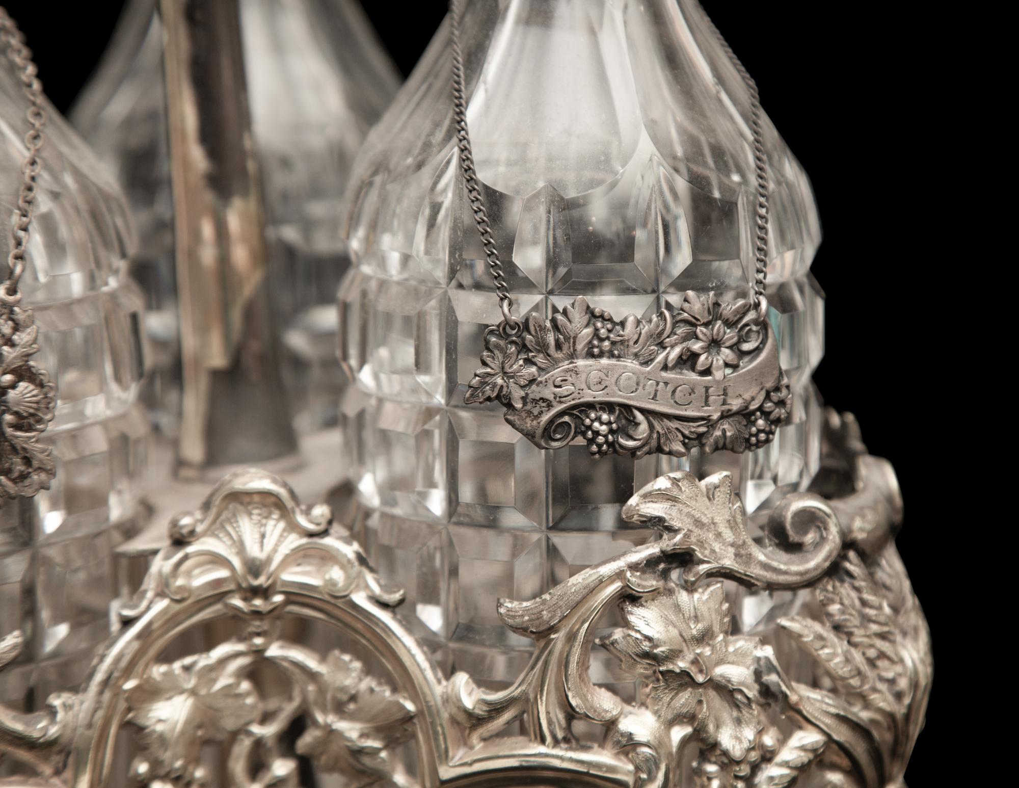 An English Silver-Plate Tantalus with Three Cut Glass Decanters