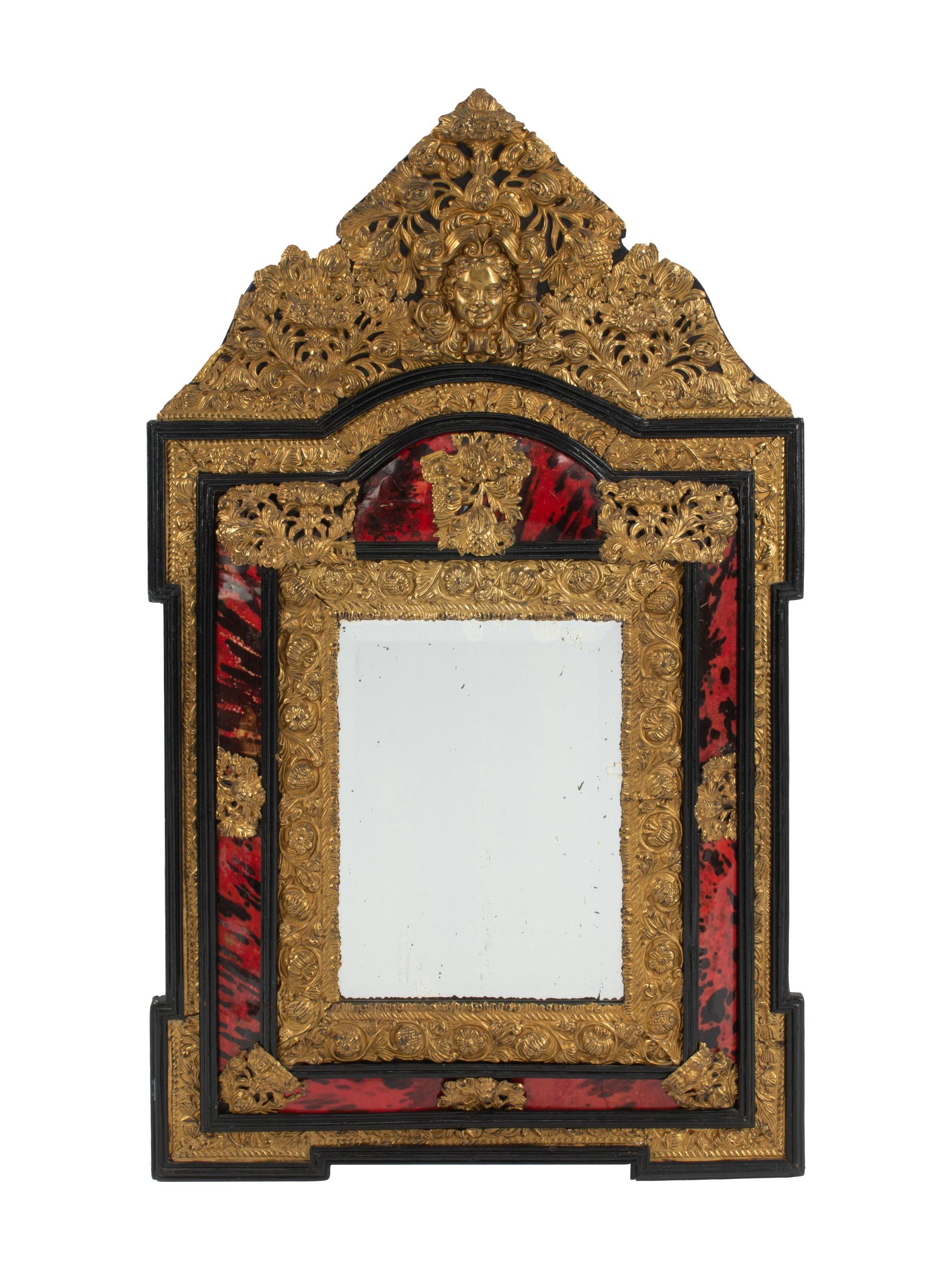 A Flemish Baroque Style Parcel Ebonized and Repoussé Brass Mirror