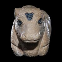 A Mesopotamian Limestone Recumbent Bull with Lapis Lazuli Inlays